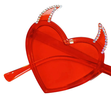 a red heart shaped object with a pair of scissors sticking out of it